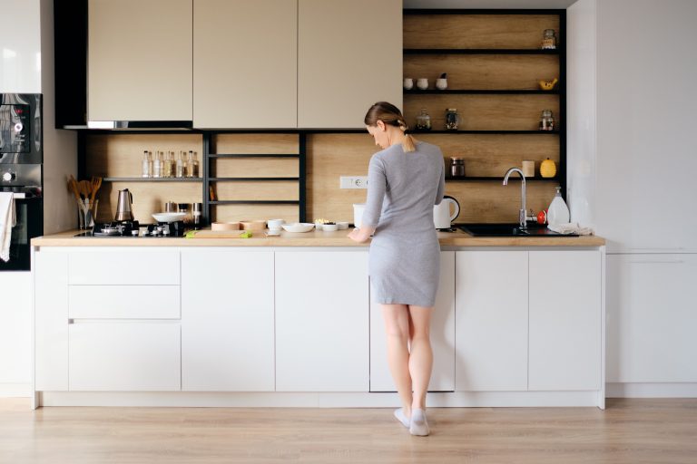 back view woman standing modern kitchen